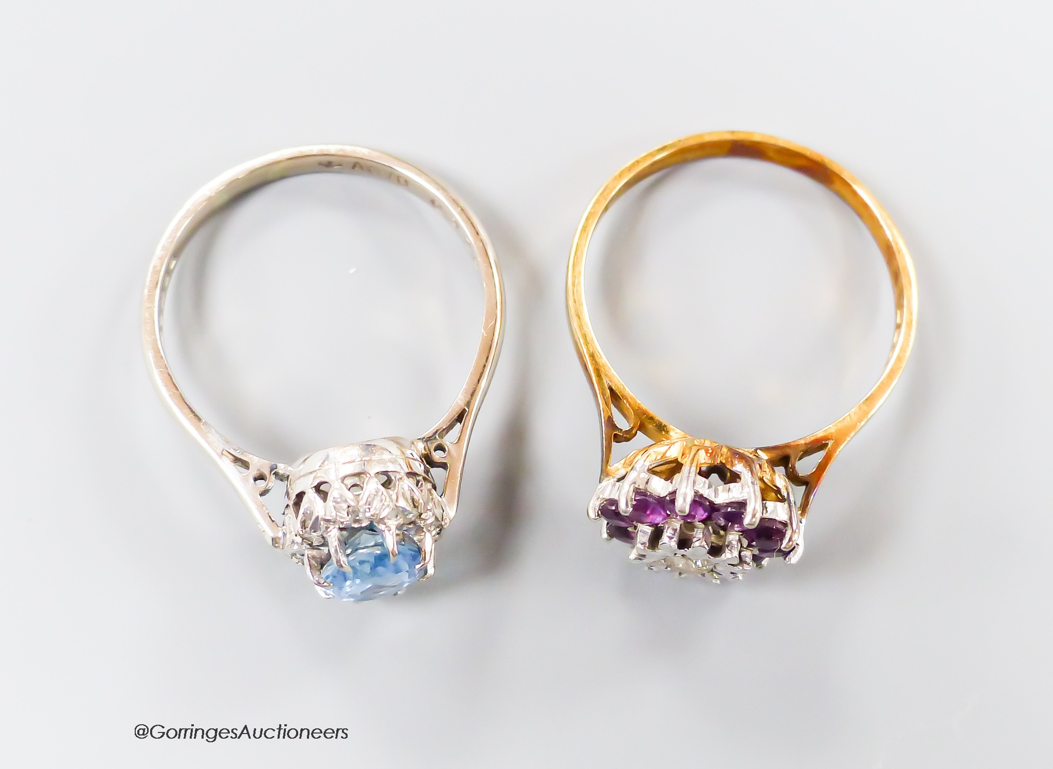 A modern 18th gold, aquamarine and illusion set diamond oval cluster ring, size R and one other 18ct gold, garnet? and diamond set cluster ring, gross 8.8 grams.